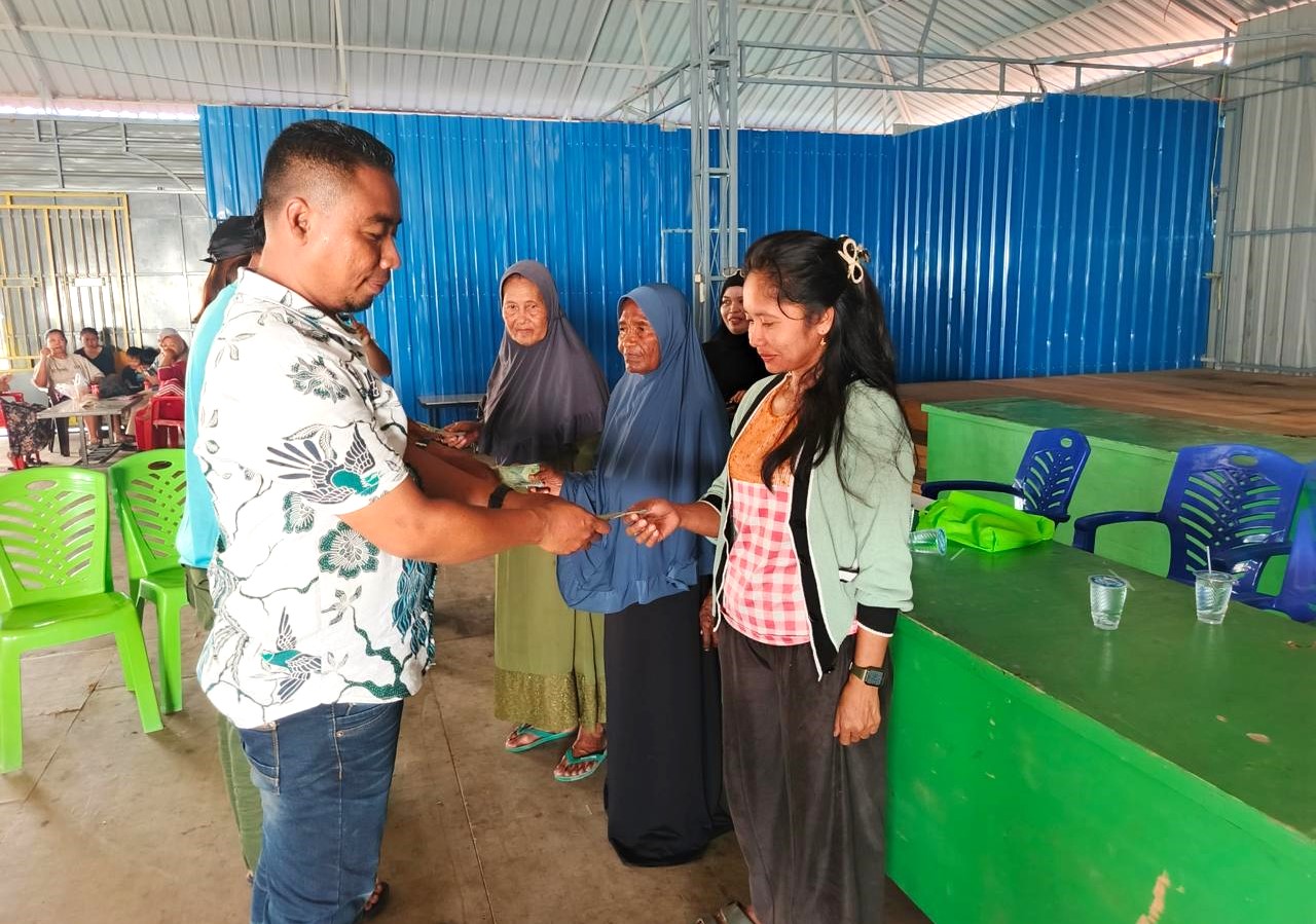 Penjabat Kepala Desa, Langara Tanjung Batu, Gafarudin, S.I.Kom saat menyerahkan bantuan kepada warga